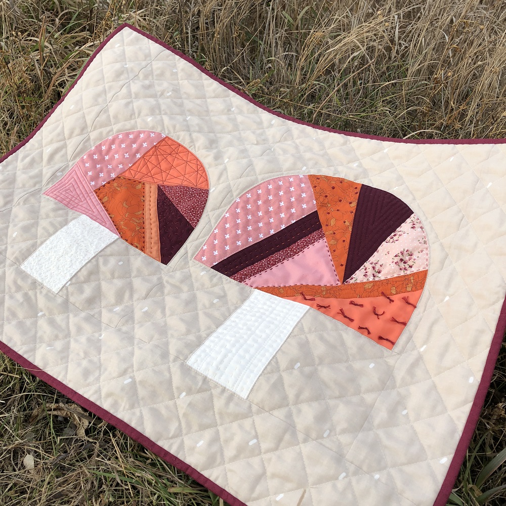 Fungi Friends quilting tutorial - finished mini quilt on grass