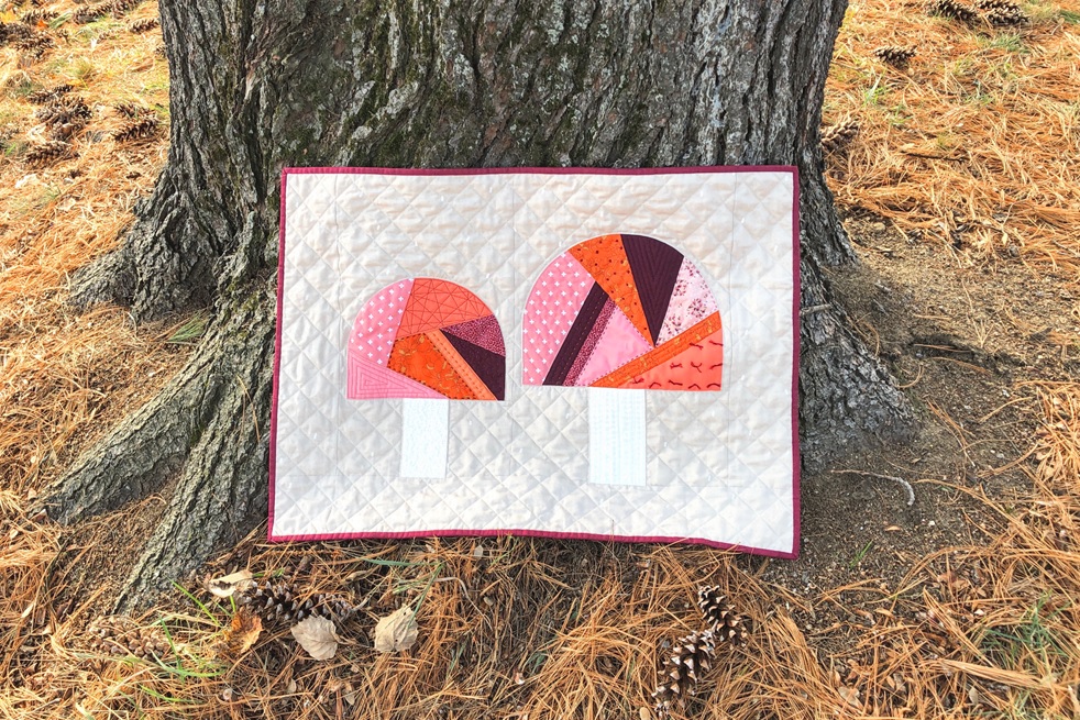 Fungi Friends quilting tutorial - finished mini quilt against tree